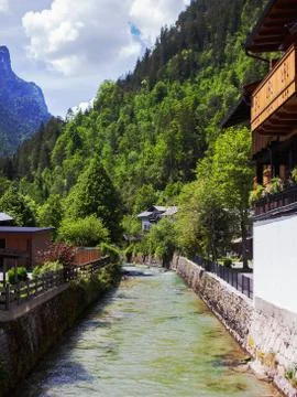 The river flows through a mountainous area in a Lofer city Stock Photos
