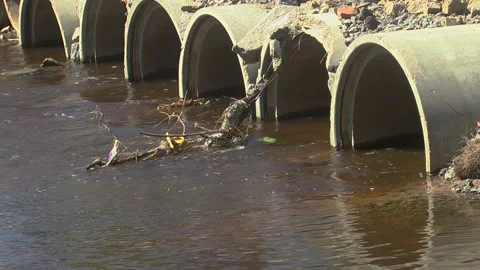 The river flows through the pipes in the dam Stock Footage 274720453