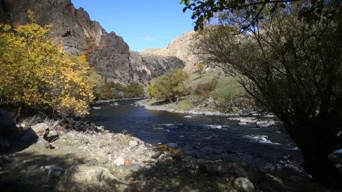 The river flows through the rocks in this beautiful place in the mountains in Stock Footage 82795289