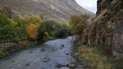 The river flows through the rocks in this beautiful place in the mountains in Stock Footage 82795392