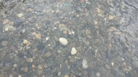 The river flows through a small expanse of rock Stock Footage 195974846