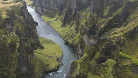 A river flows through a valley with green grass and trees Stock Footage 311483985