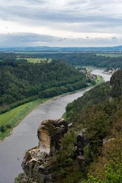 A river flows through a valley with a mountain in the background Stock Photos