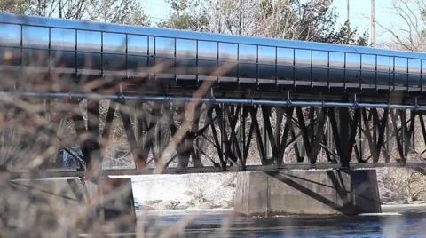 River flows under bridge pan view Stock Footage 59697527