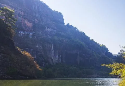 A river flows under a Karst mountain scenery Stock Photos