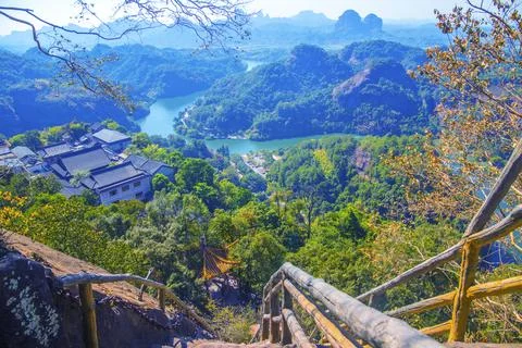A river flows under a Karst mountain scenery Stock Photos
