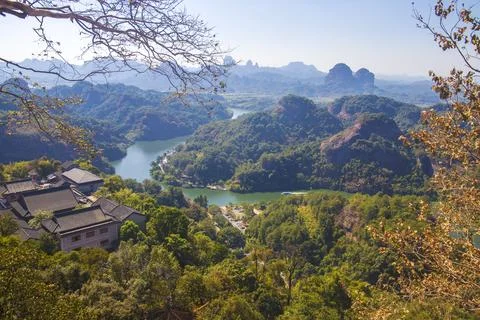 A river flows under a Karst mountain scenery Stock Photos