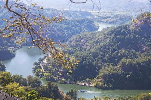 A river flows under a Karst mountain scenery Stock Photos