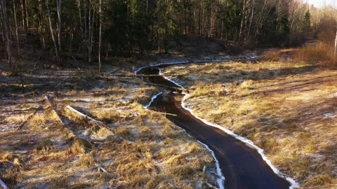 River in the forest in spring. A beautiful bend of a narrow river. On a copter Stock Footage 158947623