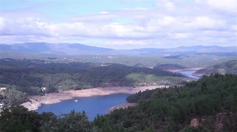 River formed by dam surrounded by forest Stock Footage 55916622