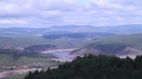 River formed by dam surrounded by forest Stock Footage 55916666