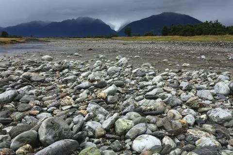 River from fox glacier with rock foreground, new zealand Stock Photos