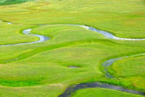 The river on the grassland Stock Photos