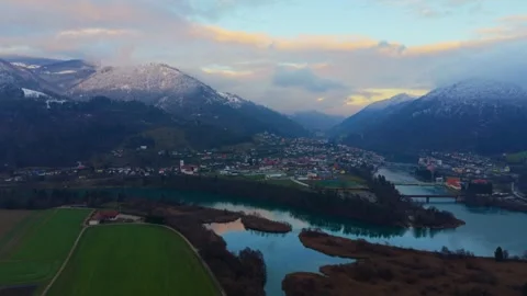 River with green fields and snowy hills aerial Stock Footage 325026080