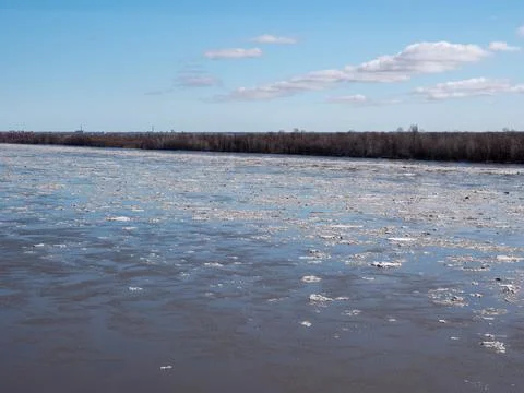 River with ice drift in spring blue sky with light clouds natural landscape.. Фото