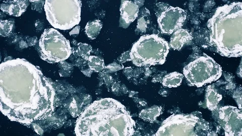 River ice floe in winter, snow falling down, aerial lift off view Stock Footage 101094080