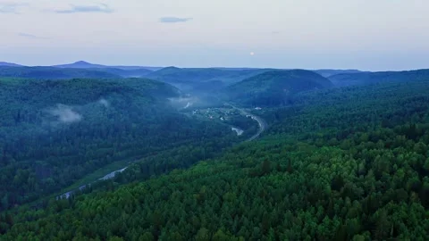 River Inzer winding through a dense forest Vídeos de archivo 303417772
