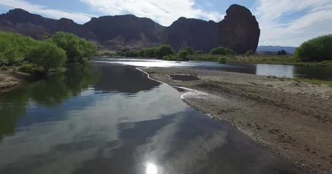 River with its reflections on a dry landscape with mountains and cliffs Video stock 59134032