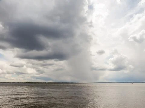 A river landscape. Low dark clouds over the water. Russia, the Volga river. 스톡 사진