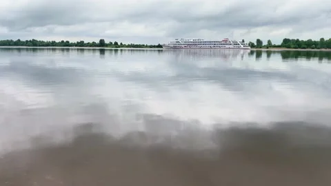 River landscape with white ship. Clouds reflecting in water surface. Stock Footage 156975209