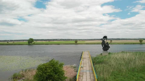 River Landscape with a World War 2 Monument on a Sunny Day Stock Footage 130891846