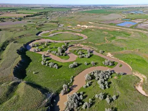 The river is in a large field Photos