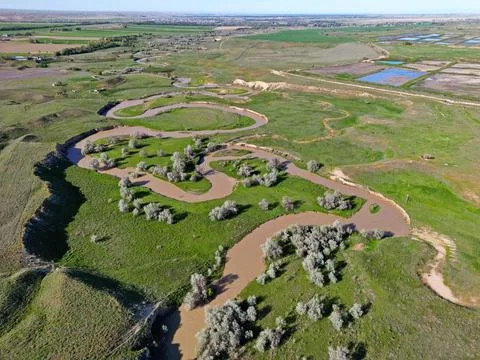 The river is in a large field Photos
