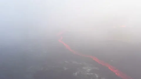 A river of lava flows with clouds of smoke Stock Footage 238857232