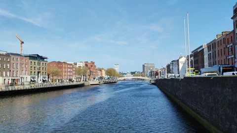 The River Liffey and the Ha'penny Bridge in Dublin on a bright April morning Stock Footage 308854821