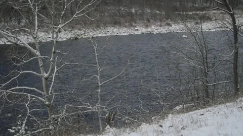 A river with light snow lining its banks Stock Footage 166053484