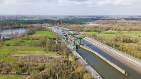 River lock complex cutting through vibrant fields woods twin steel framed gates 動画素材 330721629