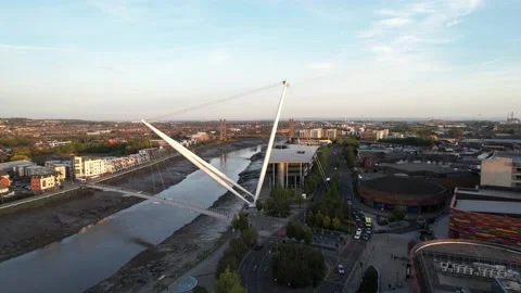 River at low tide calmly flowing, steel construction supporting footbridge Stock Footage 166542683