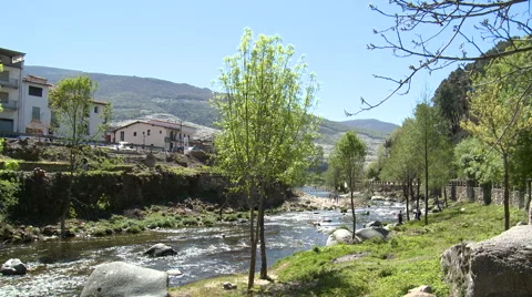 River at a meander by the town, with trees and people cleaning Stock Footage 49058889