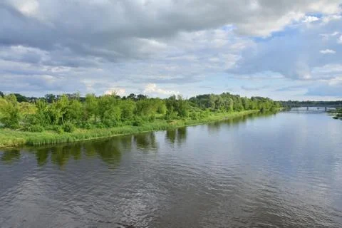 River meanders on a cloudy day, clouds in the sky. Stock Photos