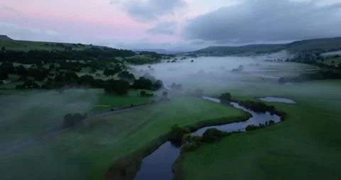 River in a misty valley at dawn Stock Footage 321663915