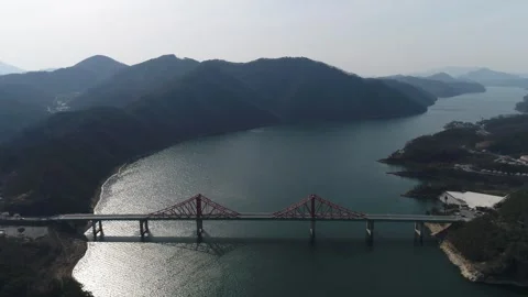River with mountain and bridge, drone shot 스톡 동영상 303134360