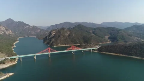 River with mountain and bridge, drone shot 스톡 동영상 303134677