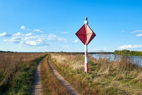 River navigation warning sign on the river bank Stock Photos
