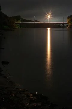 River at Night with Reflection and Bridge Stock Photos