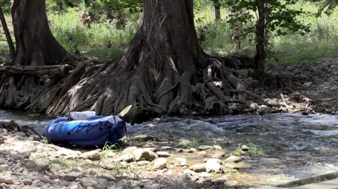 River or stream flowing with kayak on side Stock Footage 53340045