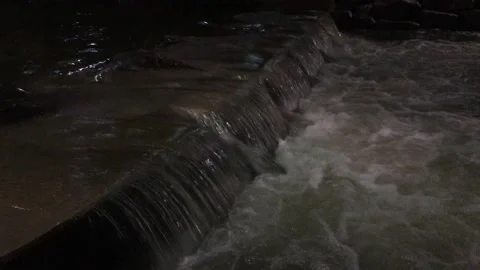 The river overflows over the stone bridge. Stock Footage 137436077