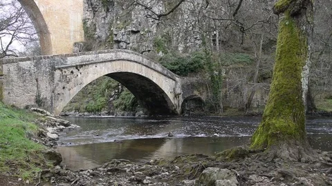 A river passes under two old bridges Stock Footage 70918958