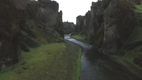 River passing through eroded green gorge in Iceland Stock Footage 69741177