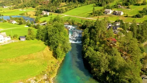 River passing through green meadows, Aerial view in 4k Stock Footage 166953528