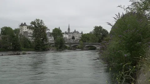 River passing under a bridge next to a village, France Video stock 103703973