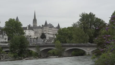 River passing under a bridge next to a village, France Stock-Footage 103704165