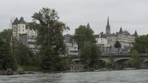 River passing under a bridge next to a village, France Video stock 103704183