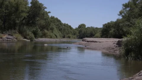 River with People Playing in the Distance Stock Footage 200799763