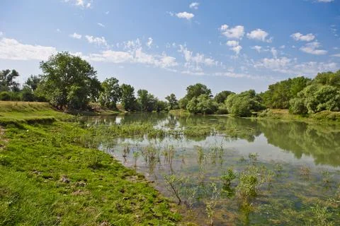 River on the plain against the blue sky Stock Photos