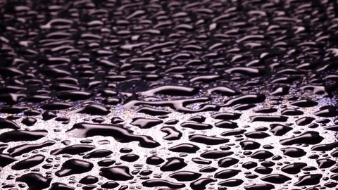 River of playing reflections in water drops in wind on black surface Stock Footage 78353930